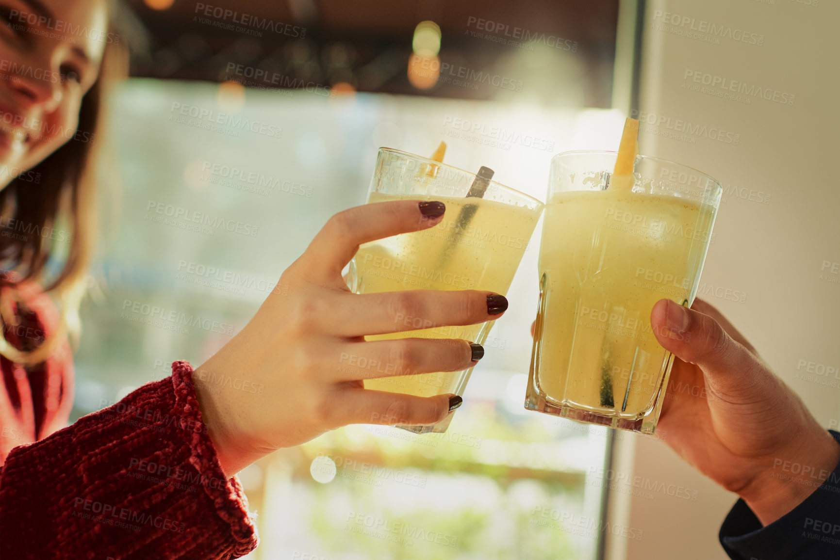 Buy stock photo Cropped shot of a young couple toasting with their drinks at a coffee shop
