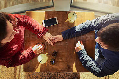 Buy stock photo Coffee shop, table and people holding hands with couple on anniversary, date and empathy with care. Above man, woman and love with support, partnership and loyalty to commitment or travel for bonding