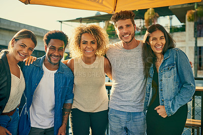 Buy stock photo Portrait of a group of young diverse friends spending the day outside on a rooftop
