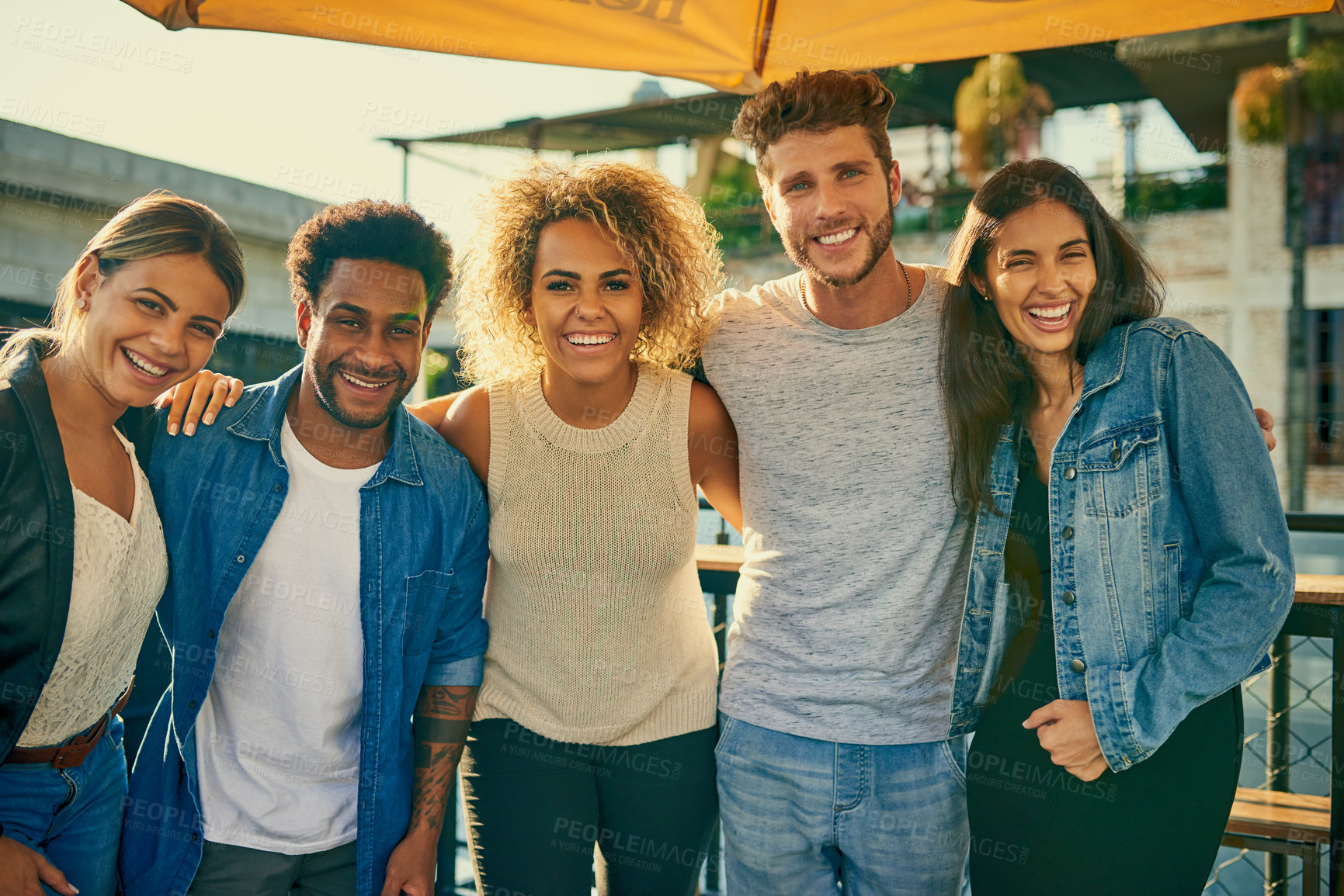 Buy stock photo Portrait of a group of young diverse friends spending the day outside on a rooftop