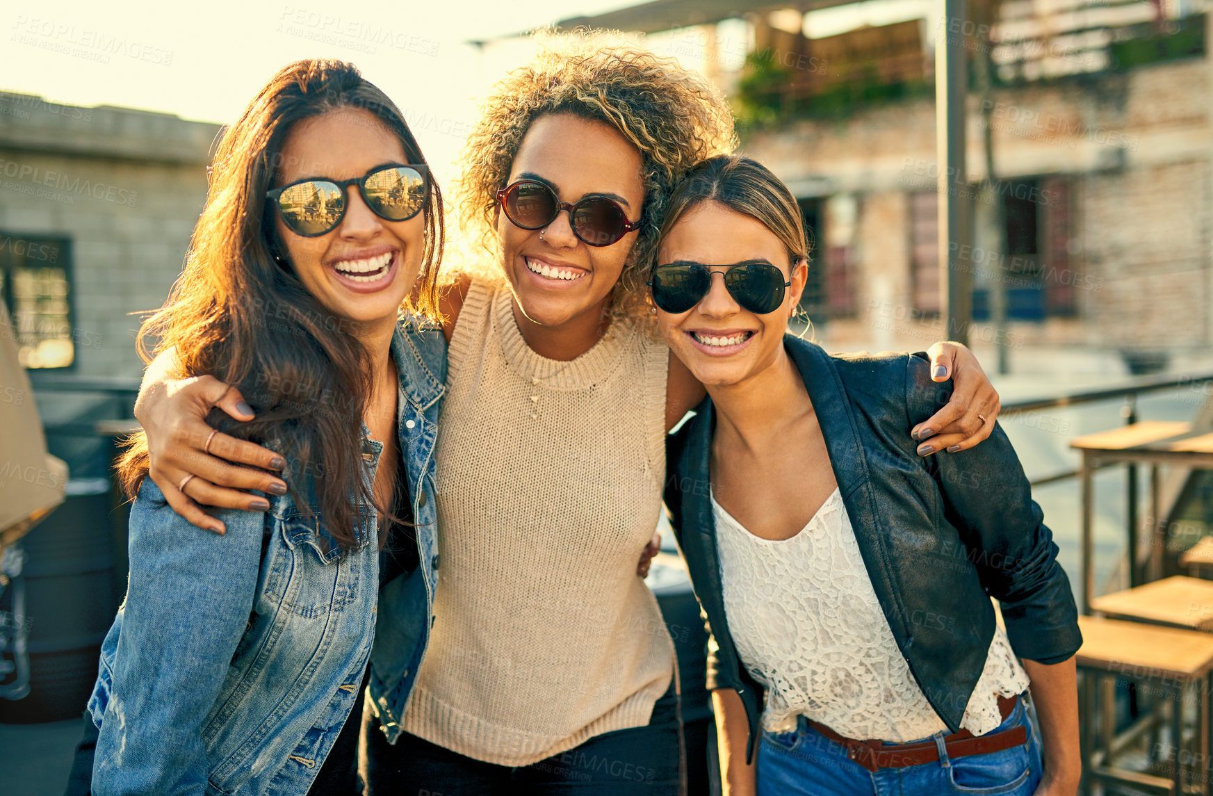 Buy stock photo Cropped shot of three female best friends spending the day outside on a rooftop