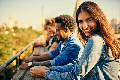 Buy stock photo Cropped shot of friends standing in a row spending the day outside on a rooftop