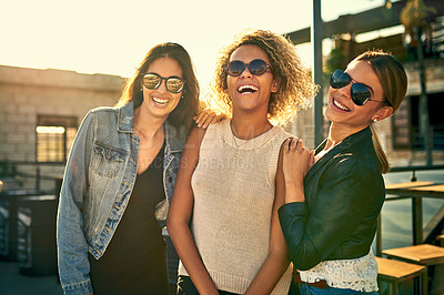 Buy stock photo Cropped shot of three female best friends spending the day outside on a rooftop