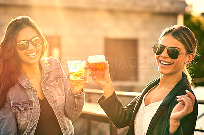 Buy stock photo Cropped shot of two female best friends spending the day outside on a rooftop