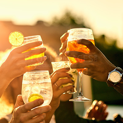 Buy stock photo Closeup shot of a group of unrecognizable friends having a toast and spending the day outside on a rooftop