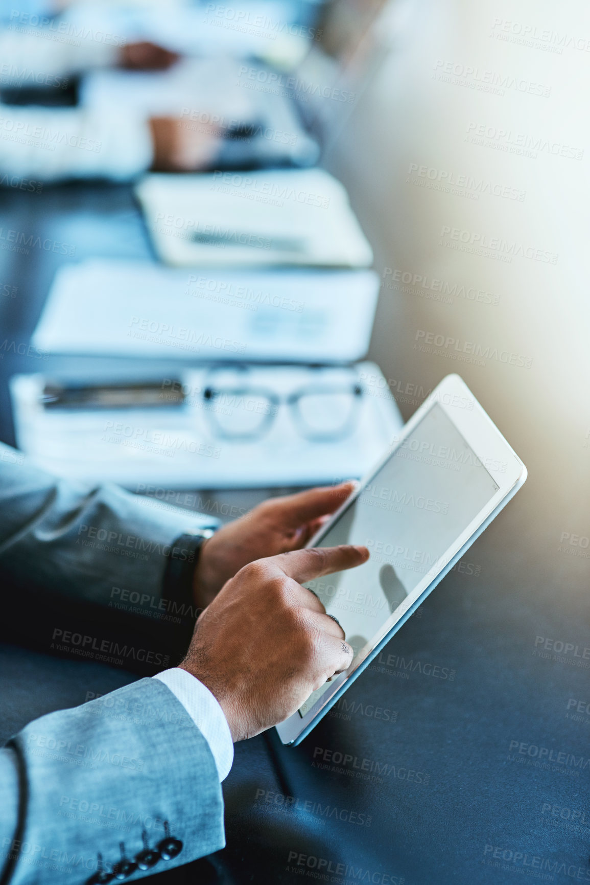 Buy stock photo Closeup shot of an unrecognizable businessman using a digital tablet in an office