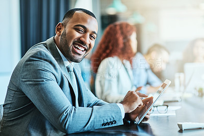 Buy stock photo Portrait of a young businessman using a digital tablet during a meeting in an office