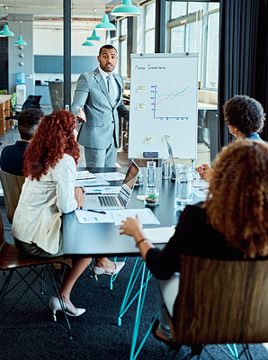 Buy stock photo Shot of a businessman giving a presentation to his colleagues in a boardroom