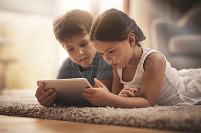 Buy stock photo Children, video and watching with tablet on floor for digital education, ebook and learning in house. Boy, girl and tech on ground for cartoon, kids story and movie or virtual gaming app in home