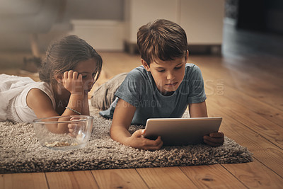 Buy stock photo Kids, tablet and relax on floor at house for streaming cartoons, game application and watching video. Family, digital app and bonding with help for storytelling, elearning and multimedia subscription