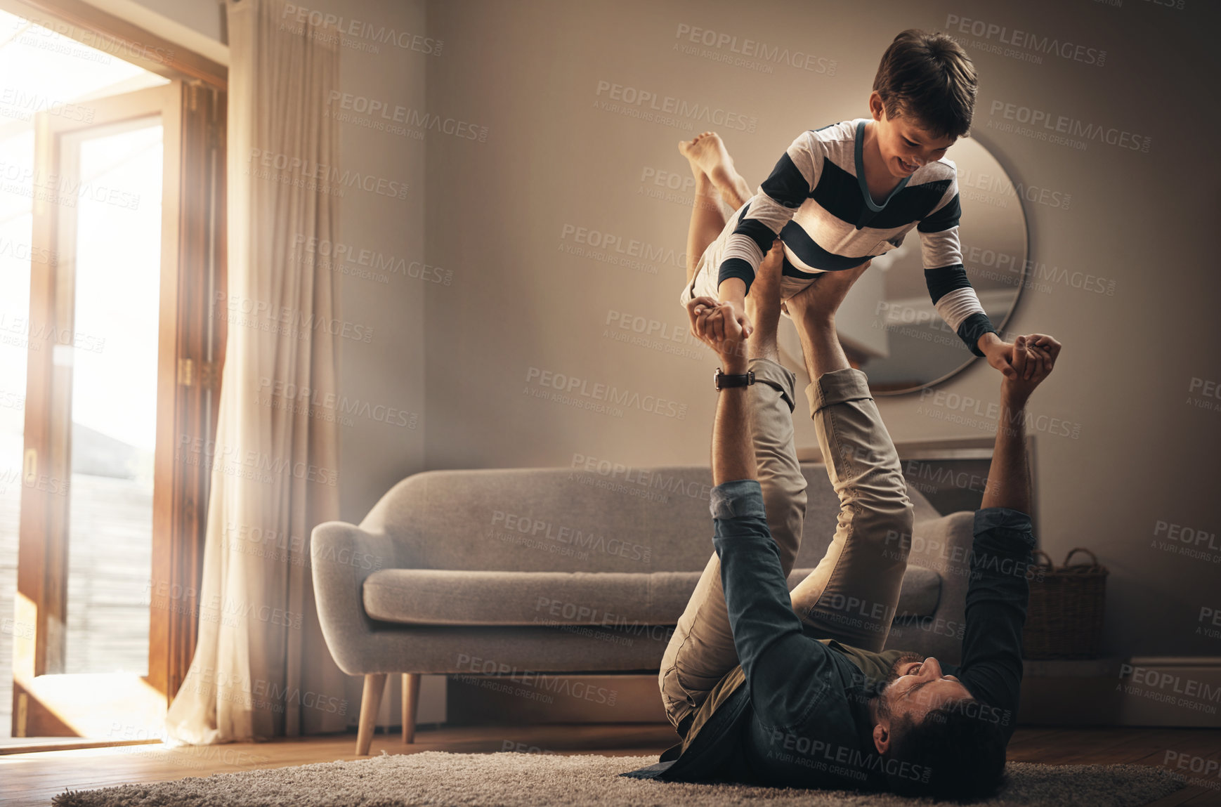 Buy stock photo Funny, dad and lift kid for game, smile or care of family bonding together on floor in living room. Laughing, boy and happy father playing with child for support, connection or love of parent in home