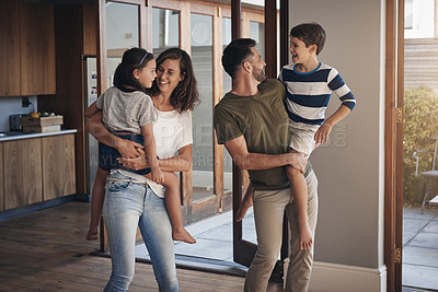 Buy stock photo Shot of a happy young family spending quality time together at at home