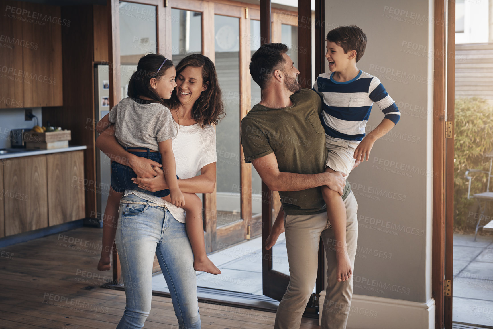 Buy stock photo Family home, children and parents for bonding together, fun and support in living room, lounge or house. Woman, man and kids with hug, playful and happiness for weekend, summer vacation and break