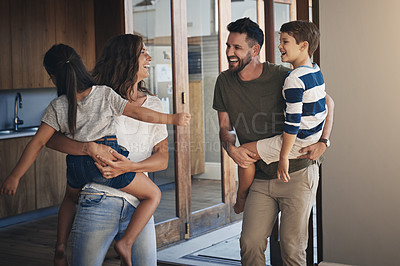 Buy stock photo Shot of a happy young family spending quality time together at at home