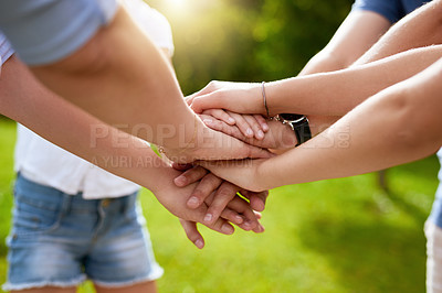 Buy stock photo Closeup of a group of people forming a huddle with their hands while standing outside in a park during the day