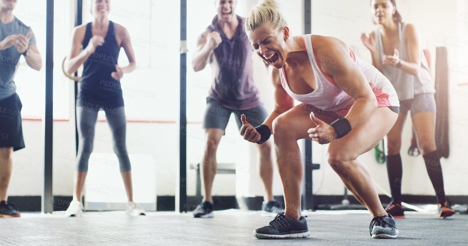 Buy stock photo Shot of a group of young people standing in a circle at the gym and motivating each other