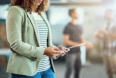 Buy stock photo Closeup shot of an unrecognizable designer using a digital tablet in an office