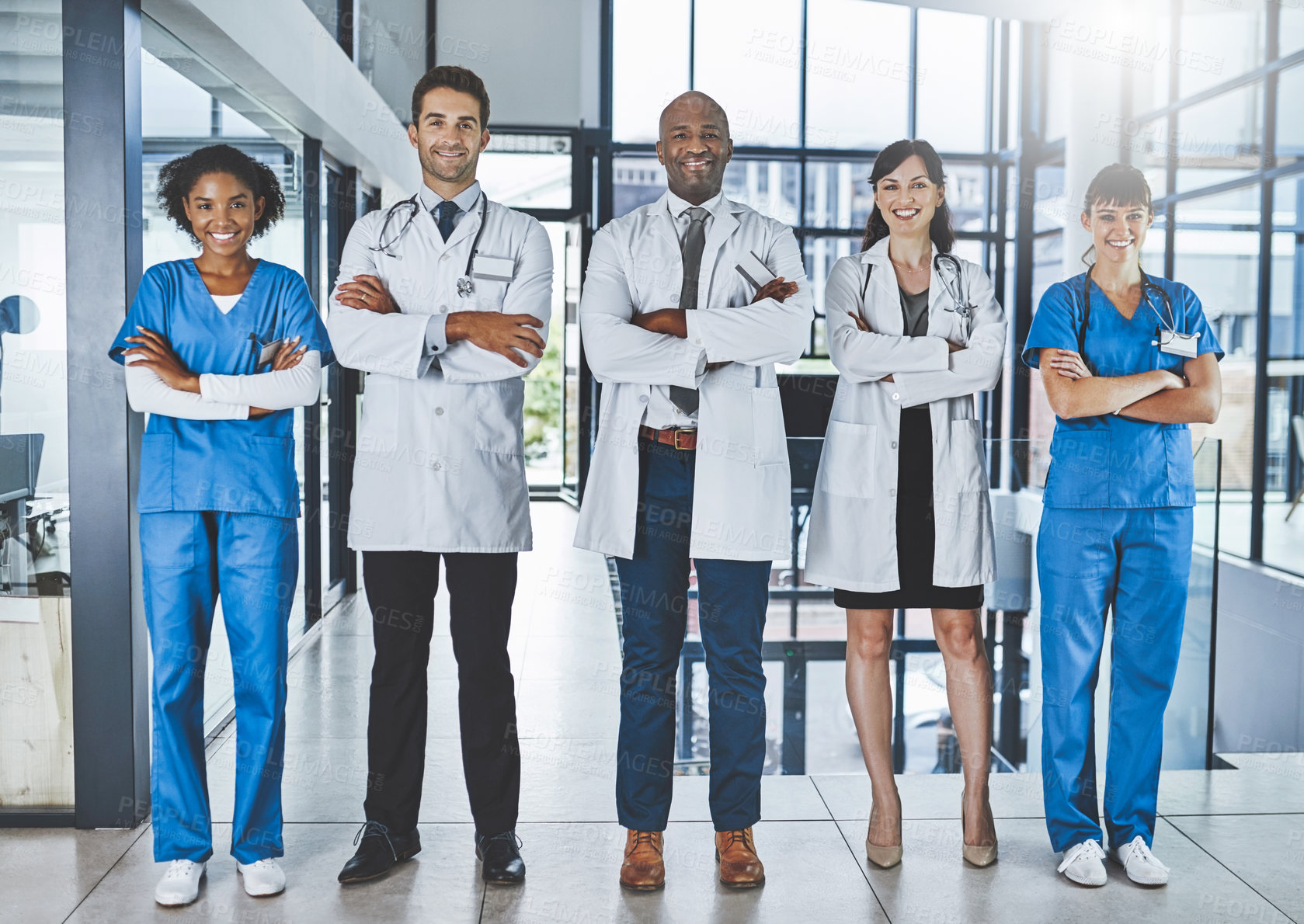 Buy stock photo Portrait of a diverse team of doctors standing together in a hospital