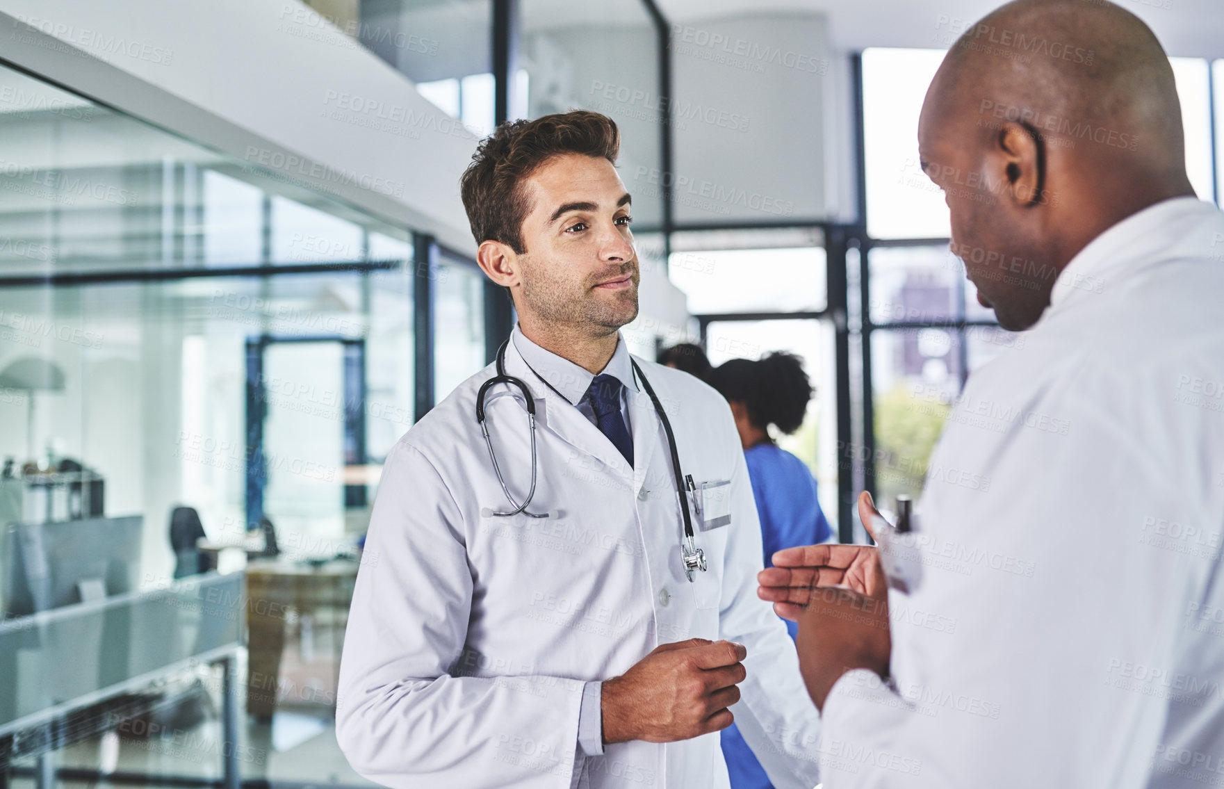 Buy stock photo Shot of two doctors having a discussion in a hospital