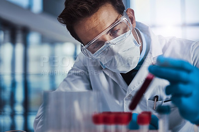 Buy stock photo Cropped shot of a young male scientist working in a lab