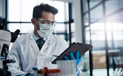 Buy stock photo Cropped shot of a young male  scientist working in a lab