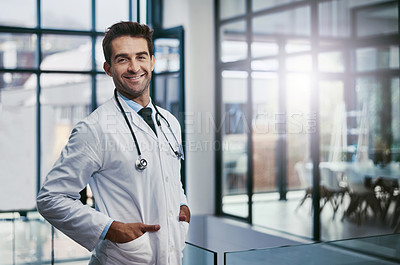 Buy stock photo Portrait of a young handsome male medical practitioner working in a hospital