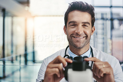 Buy stock photo Portrait of a young handsome male scientist working in a lab with a microscope