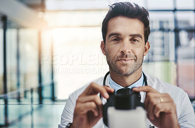 Buy stock photo Cropped shot of a young handsome male scientist working in a lab with a microscope
