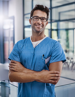 Buy stock photo Portrait of a young handsome male medical practitioner working in a hospital