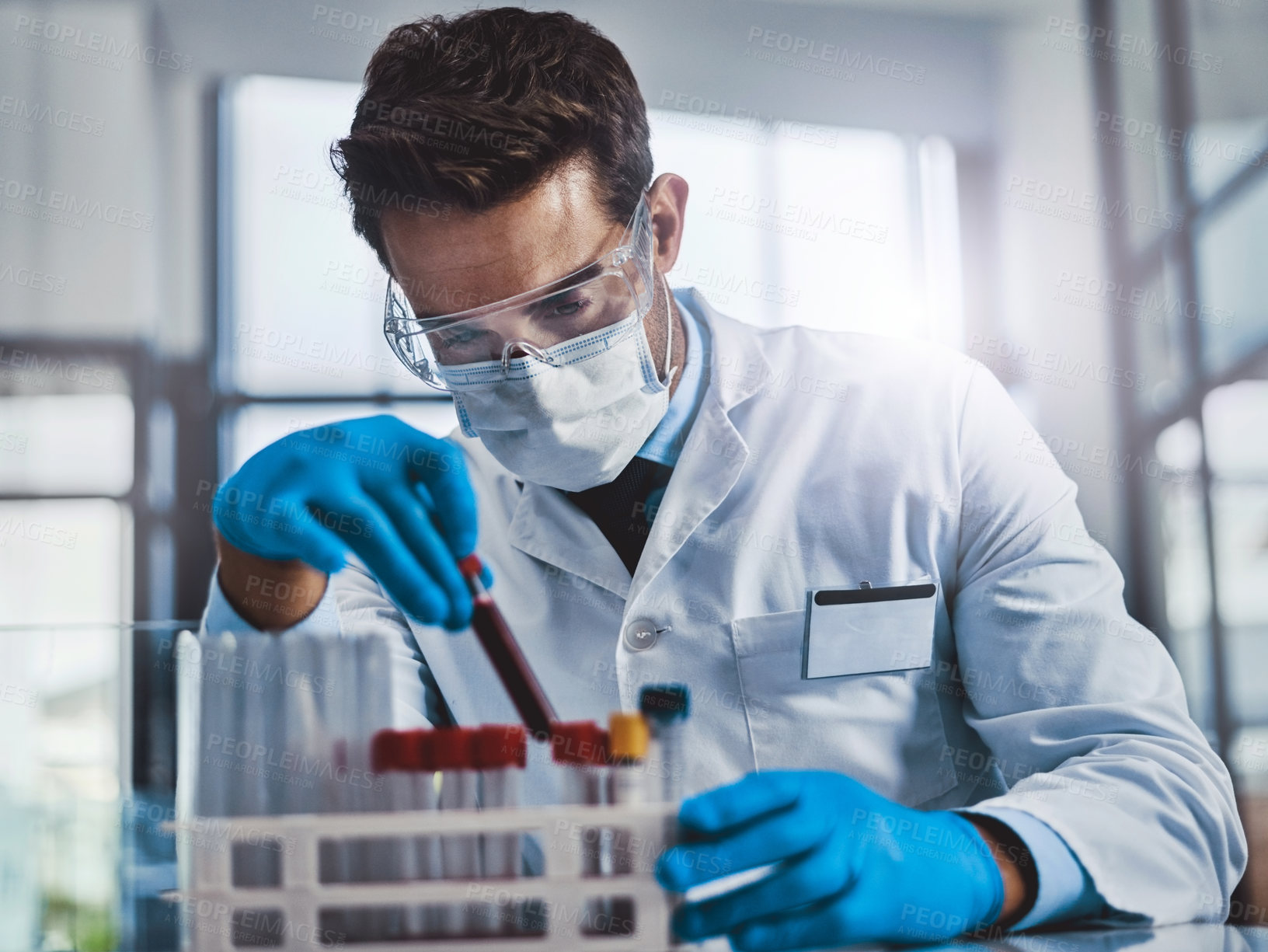 Buy stock photo Cropped shot of a young male scientist working in a lab