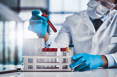 Buy stock photo Cropped shot of an unrecognizable male  scientist working in a lab