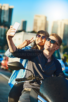 Buy stock photo Biker, travel and selfie with couple in city for motorcycle, social media and transportation. Picture, summer vacation and photography with man and woman on motorbike for driver, adventure or explore