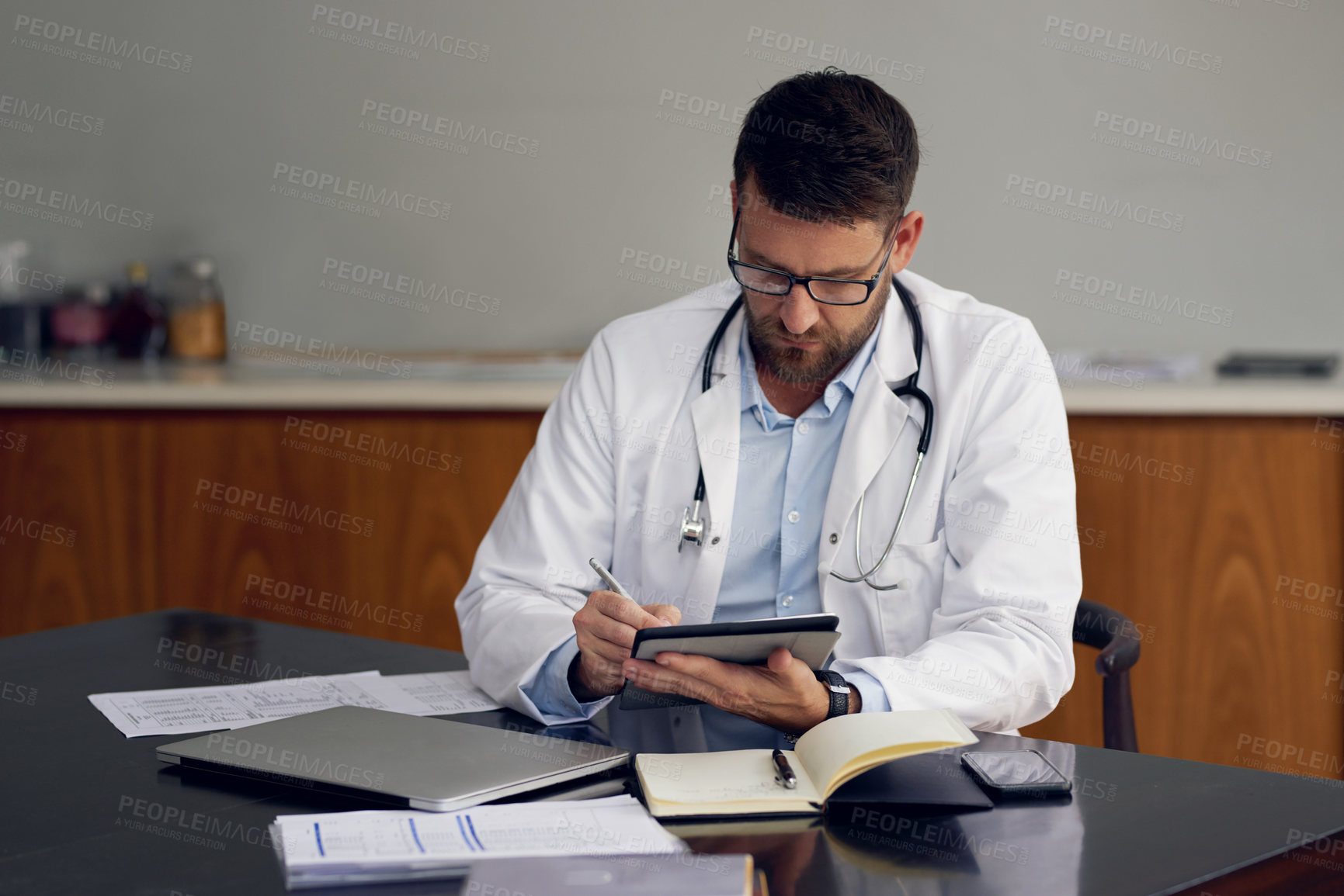 Buy stock photo Hospital, doctor and man with tablet, typing and research for diagnosis, calendar and online reading for medical news. Person, physician and professional with tech, app for schedule and healthcare