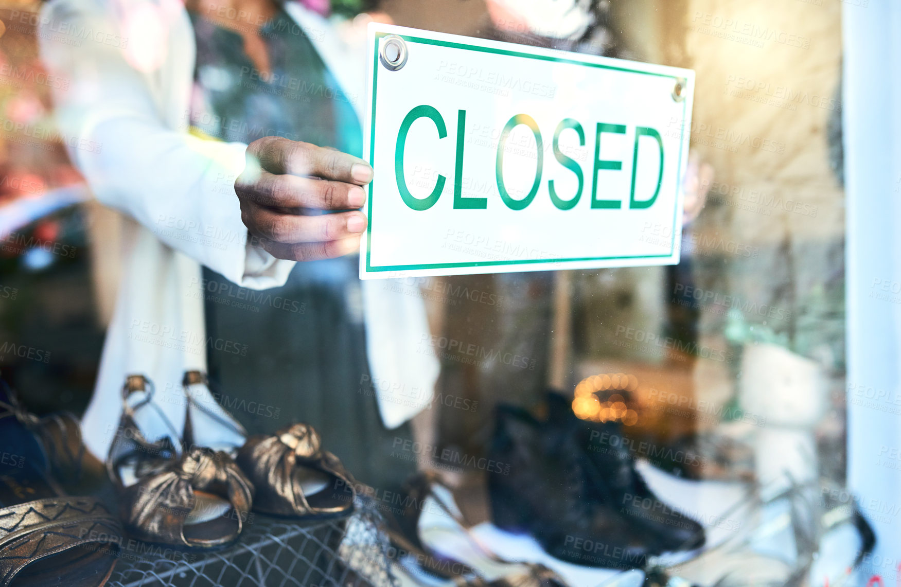 Buy stock photo Cropped shot of an unrecognizable woman holding up a closed sign