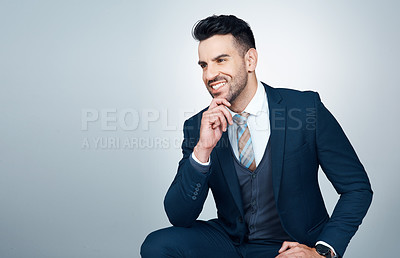 Buy stock photo Studio shot of a handsome young businessman looking thoughtful against a grey background