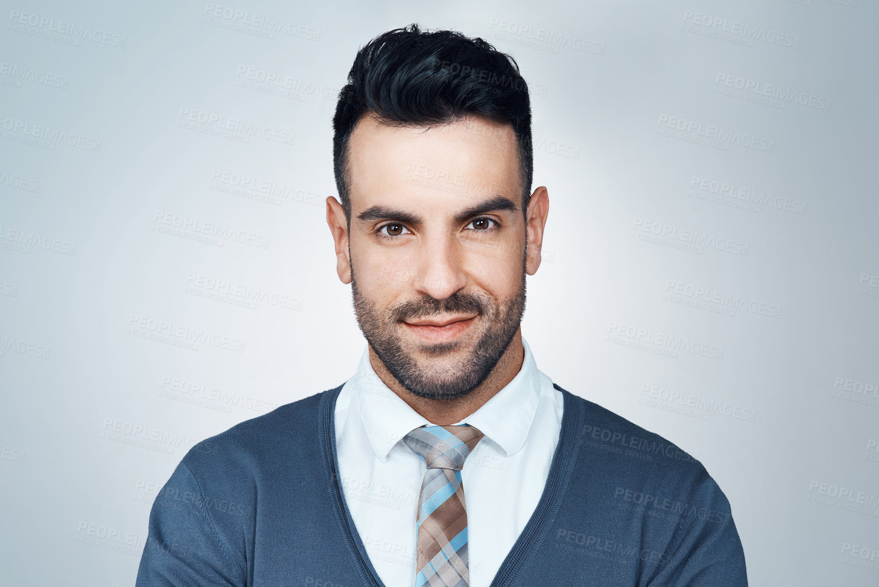 Buy stock photo Studio portrait of a handsome young businessman posing against a grey background