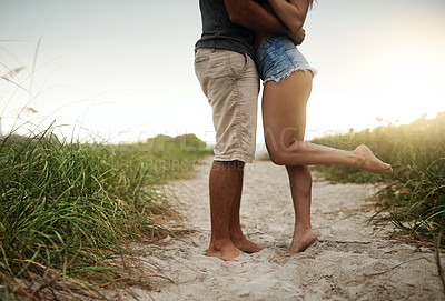 Buy stock photo Cropped shot of a young couple spending a romantic day at the beach