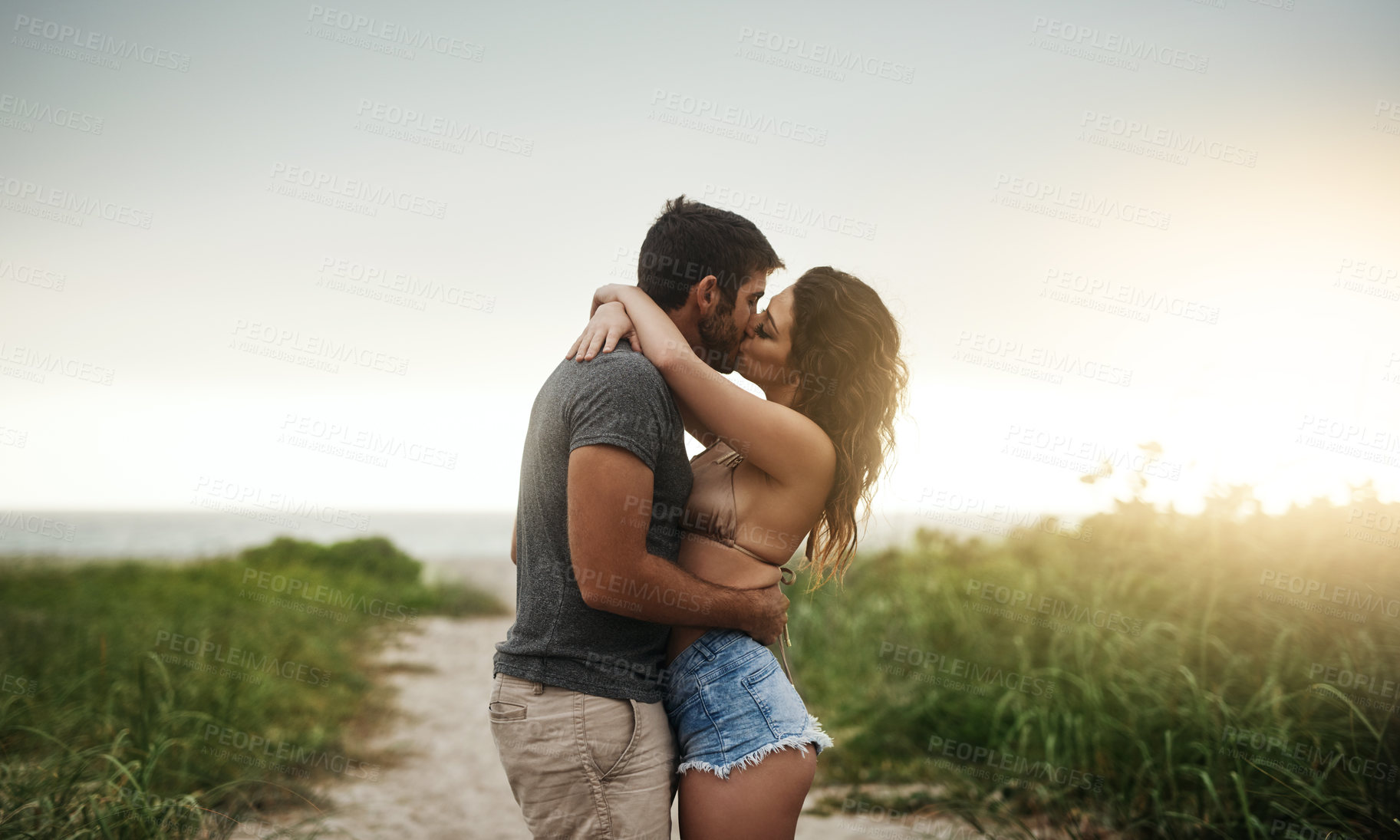 Buy stock photo Hug, kiss and romance with couple on beach together for holiday, travel or vacation. Happy, honeymoon or hugging with man and woman on sand at tropical island location for adventure or summer bonding