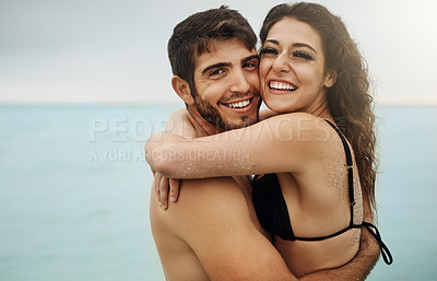 Buy stock photo Shot of a young couple enjoying a beach getaway