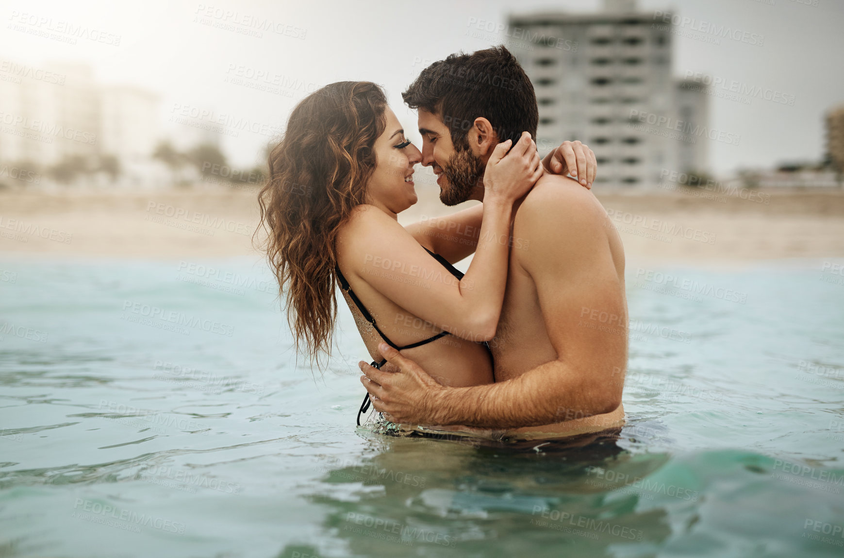 Buy stock photo Water, romance or happy couple hug at sea to travel for love on vacation, valentines day or outdoor holiday. Swimming, smile or people at beach for bonding together for honeymoon on tropical island