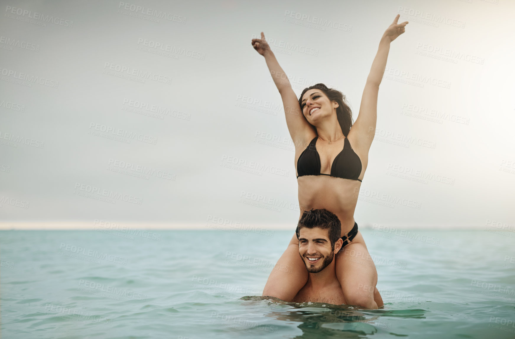 Buy stock photo Shot of a young couple spending some time in the water
