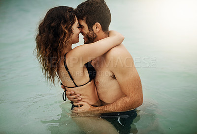 Buy stock photo Shot of an affectionate couple spending some time in the water