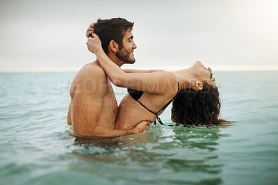 Buy stock photo Shot of a young couple spending some time in the water