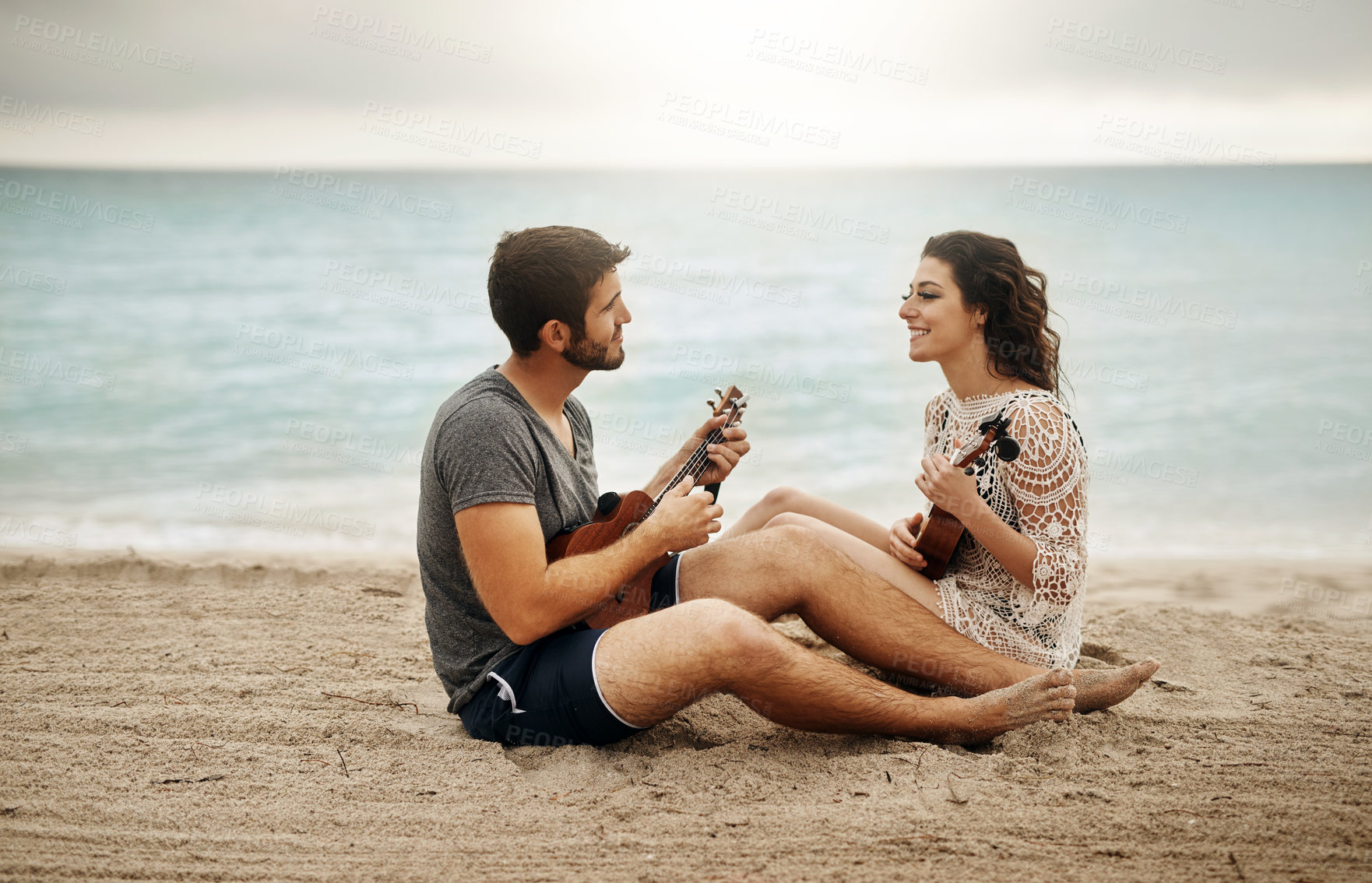 Buy stock photo Couple, happy and learning at ocean with ukulele, music and help with tutorial. Musician man, woman or instruments on beach for musical advice, summer vacation or collaboration on holiday in Maldives