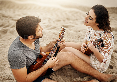 Buy stock photo Picnic, date and couple at beach with ukulele for love, romance and anniversary in Spain. Smile, sand or happy people playing music for summer, bonding or support together at sunset with instruments