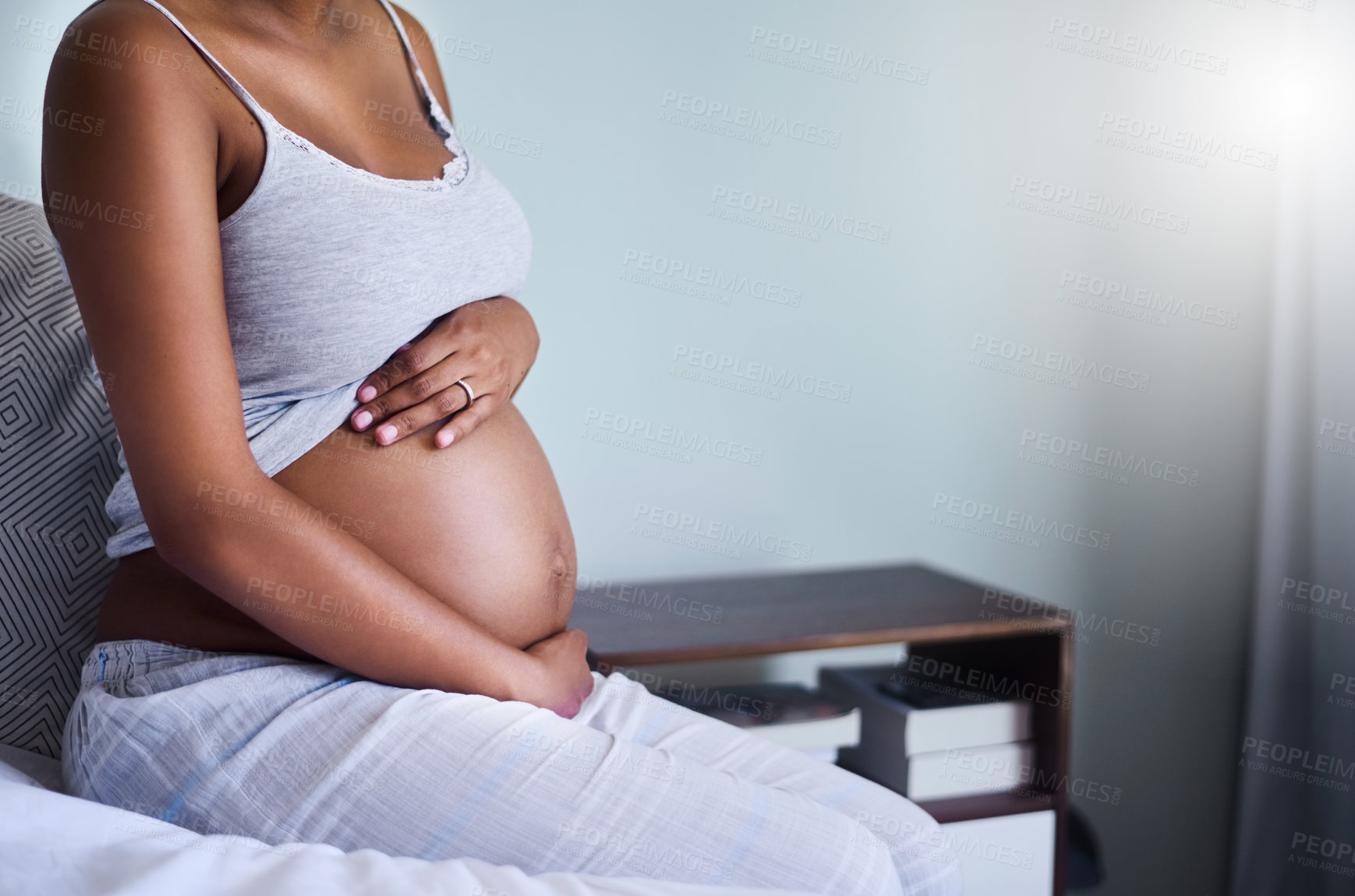 Buy stock photo Hands, stomach and pregnant girl on bed with care, love and relax, comfort and nurture in her home. Pregnancy, future and woman person in bedroom with fertility gratitude, protection and belly growth