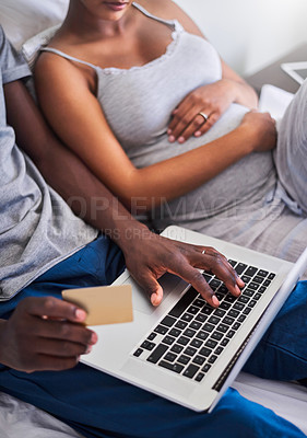 Buy stock photo Shot of a young couple doing some online shopping with a credit card