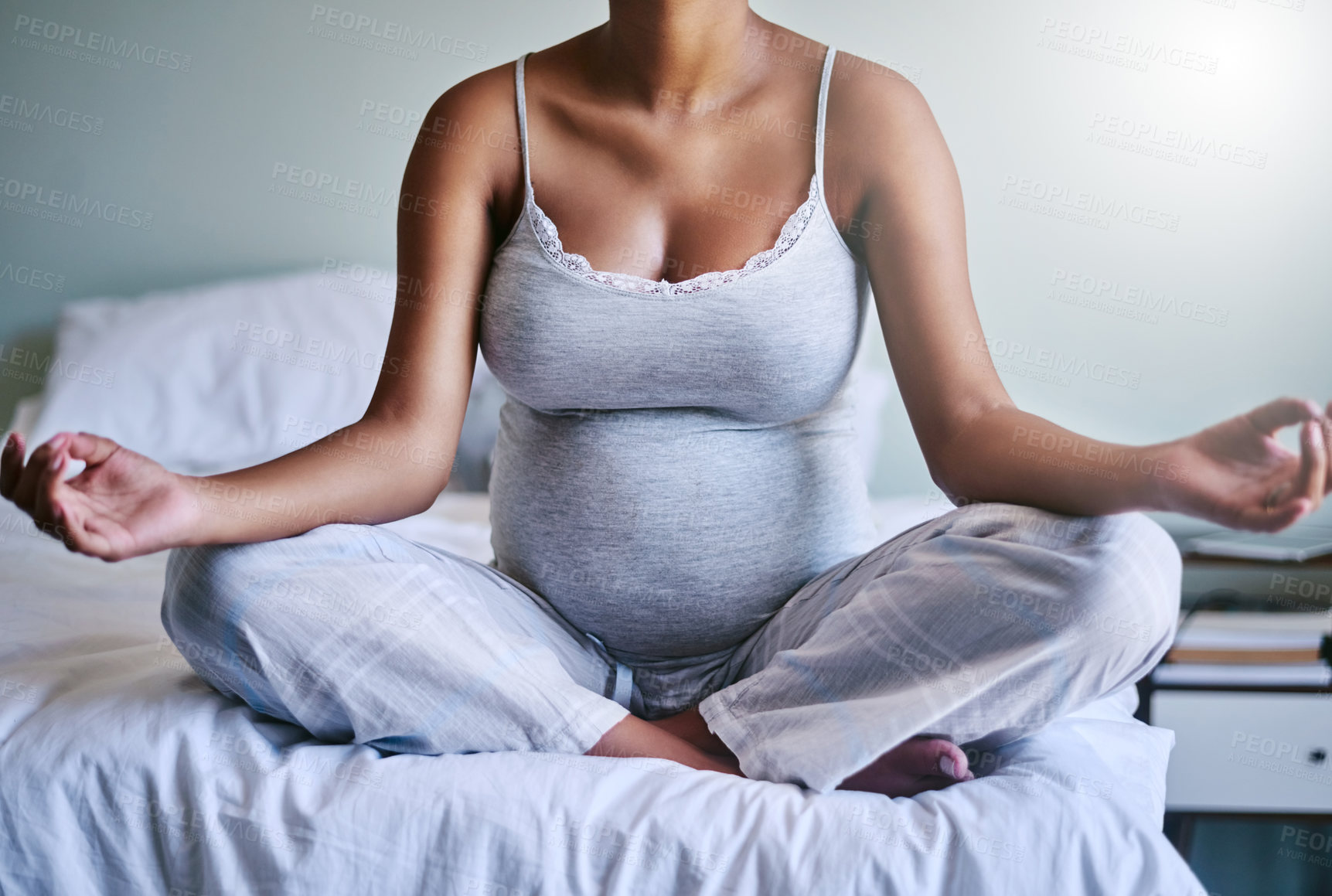 Buy stock photo Shot of a pregnant woman doing yoga in her bedroom