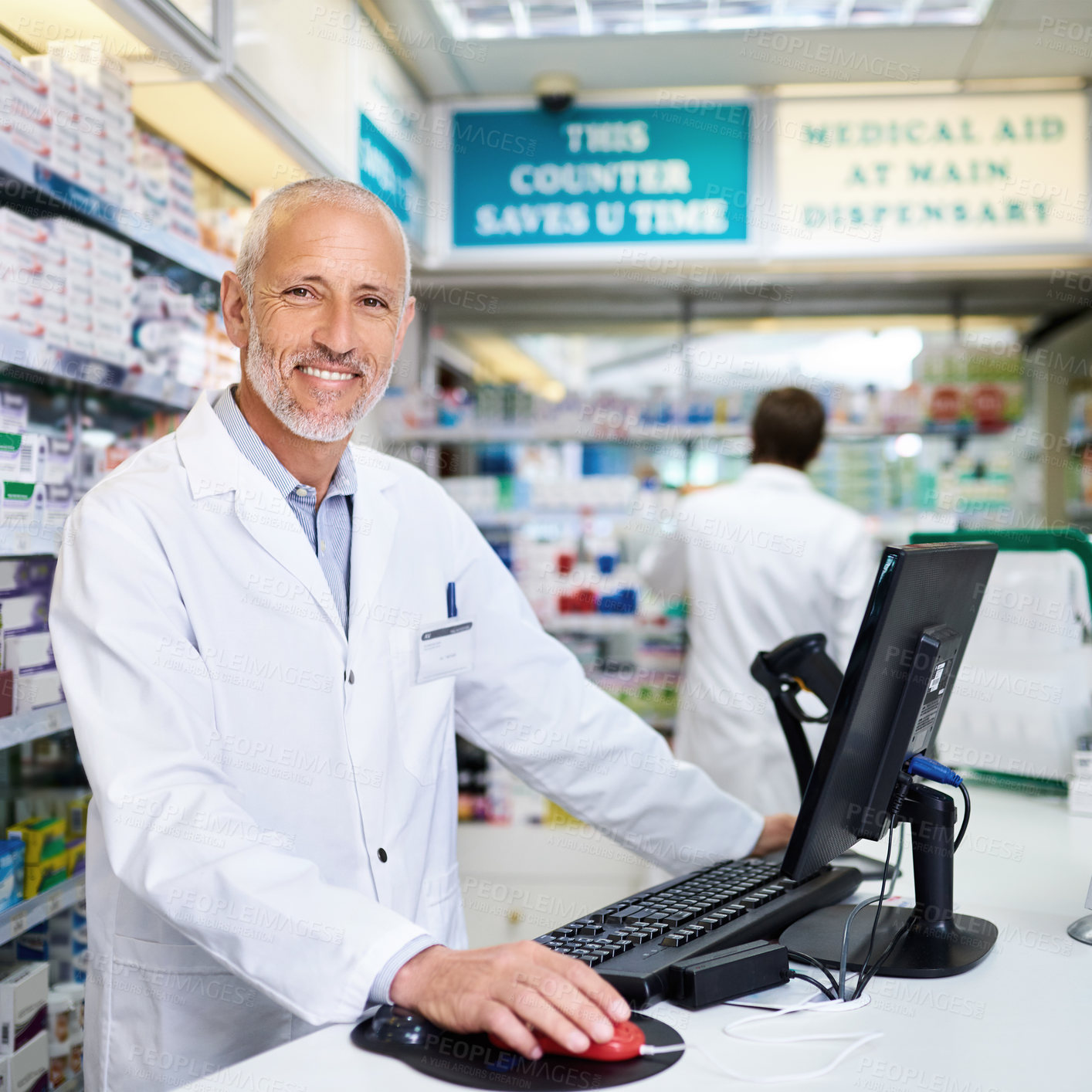 Buy stock photo Portrait of a mature pharmacist working on a computer in a chemist