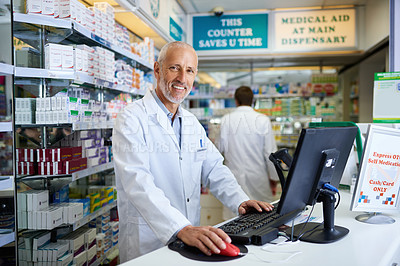 Buy stock photo Portrait of a mature pharmacist working on a computer in a chemist